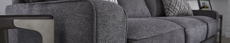 Image slice of dark gray sofa with pillow and end tables