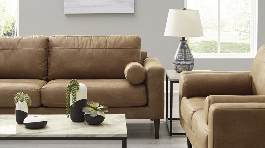 Living room scene with sofa, love seat, coffee table, end table, and lamp.